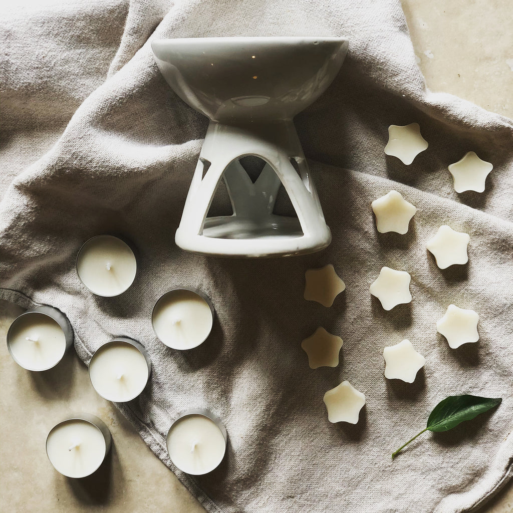 white ceramic oil burner with soy wax melts and tea lights