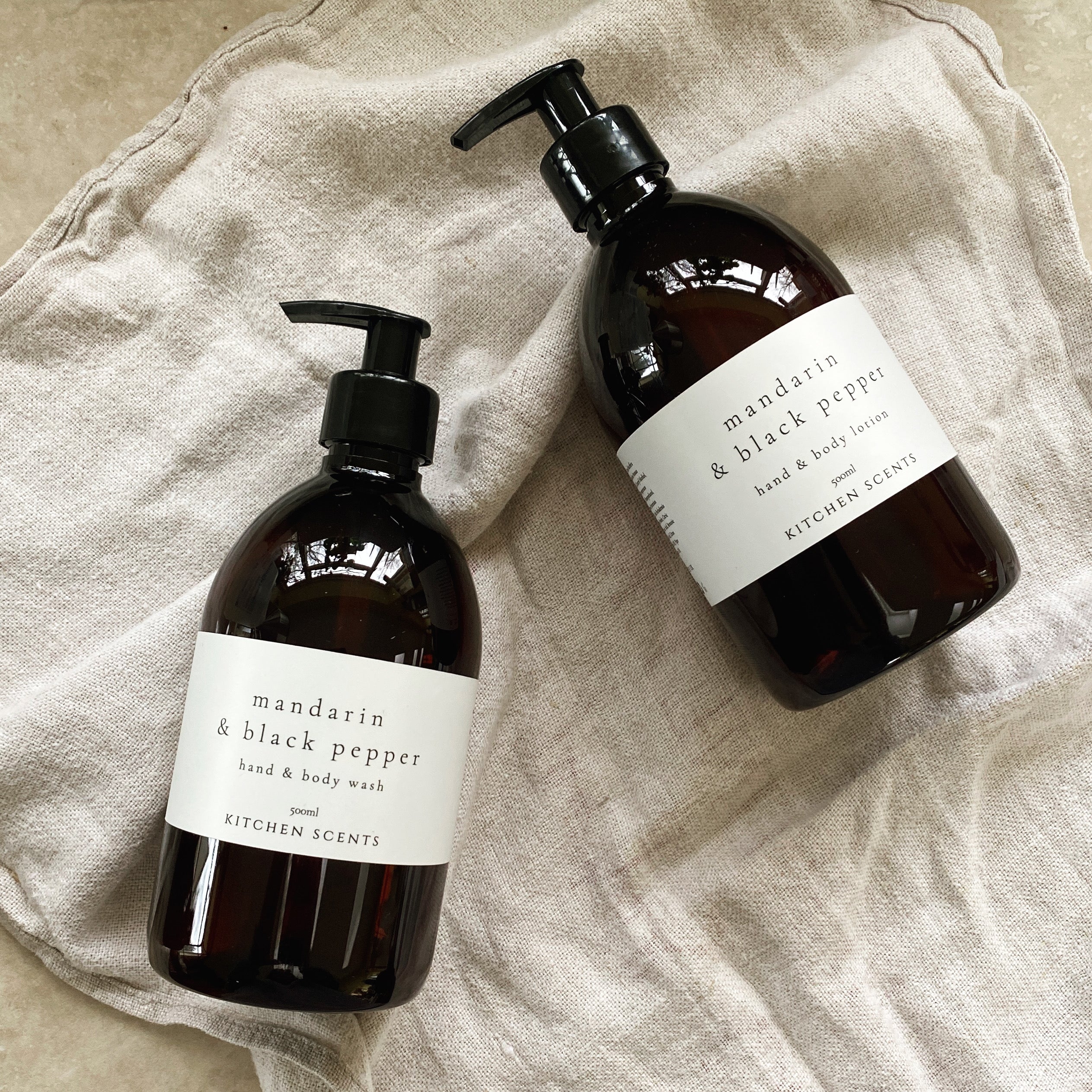 mandarin and black pepper hand and body wash and lotion in amber bottle with pump