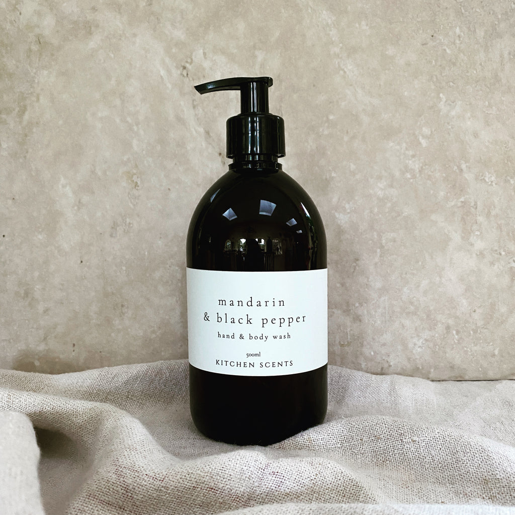 mandarin and black pepper hand and body wash in amber bottle with pump
